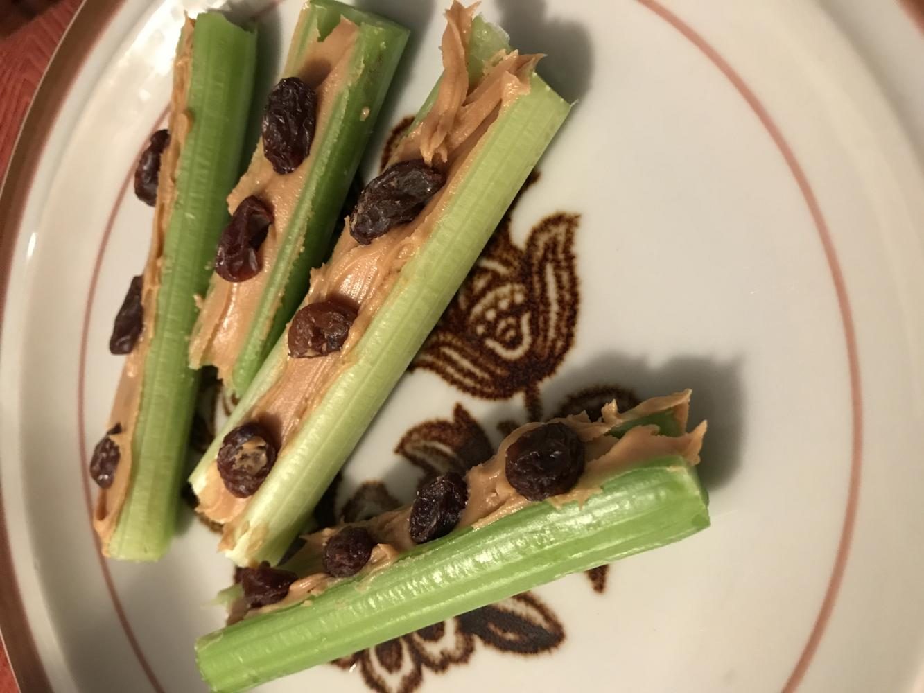 picture of celery with peanut butter on a plate (ants on a log snack)