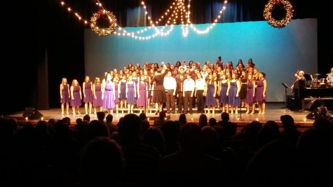 All 3 MV Choirs stand together on the stage while performing.