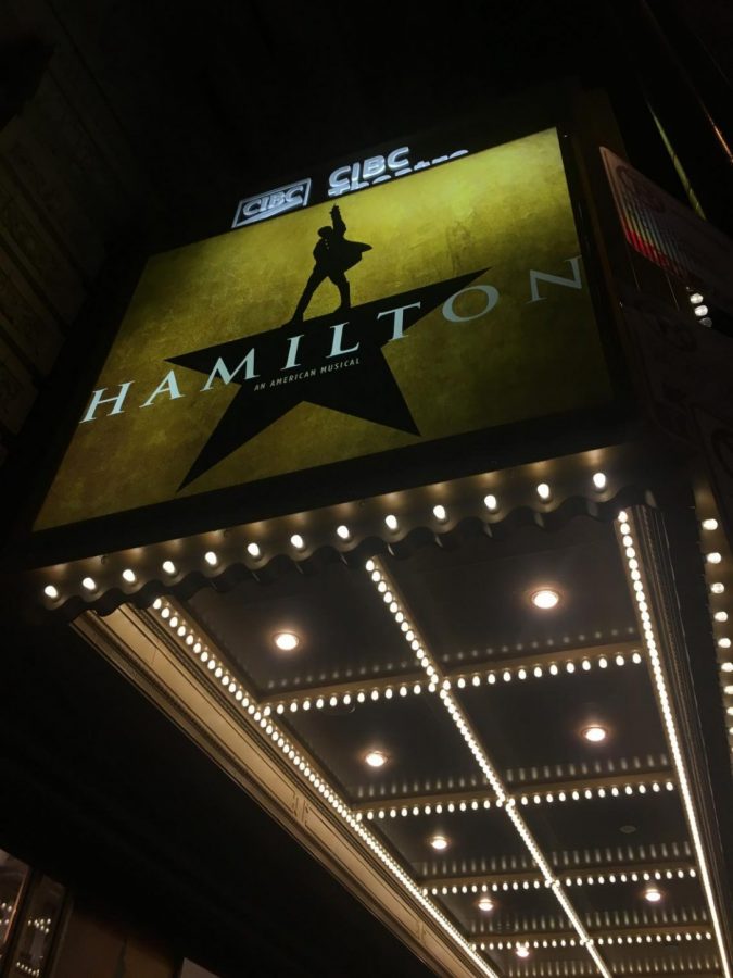 A shot of the lighted Hamilton sign outside of the PrivateBank Theatre