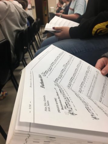 The Little Mermaid script, open to a piece of sheet music for a song in the musical.