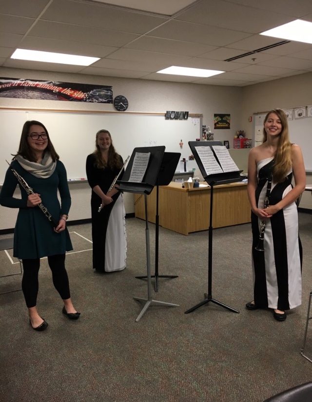 A group of 3 girls poses with their woodwind instruments.