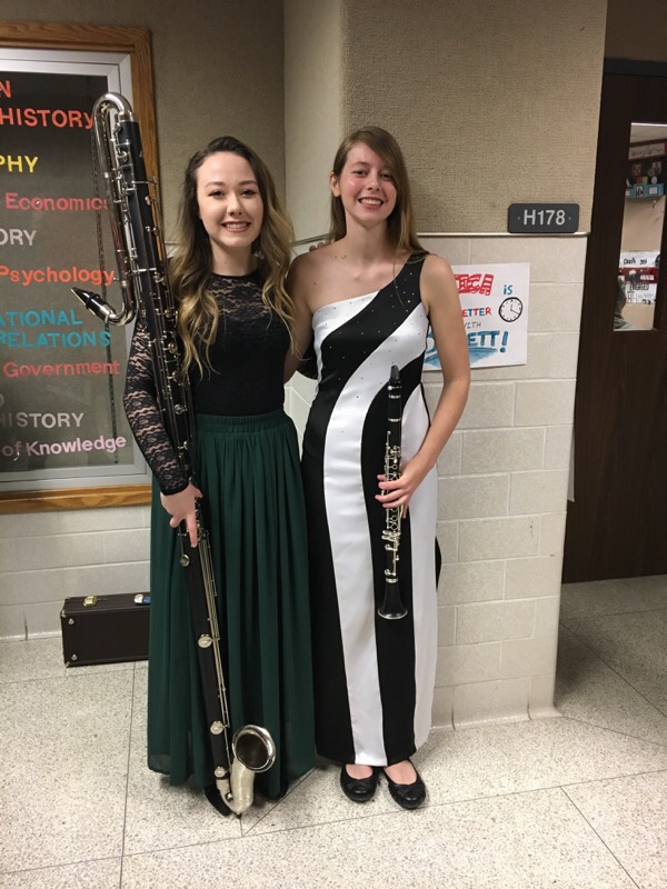 Two students stand with their clarinets.