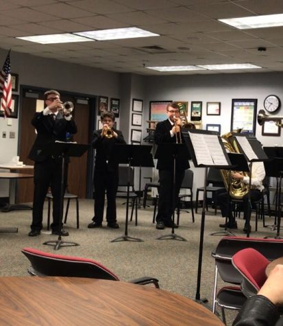 The members of MV's brass quintet stand ready to perform.