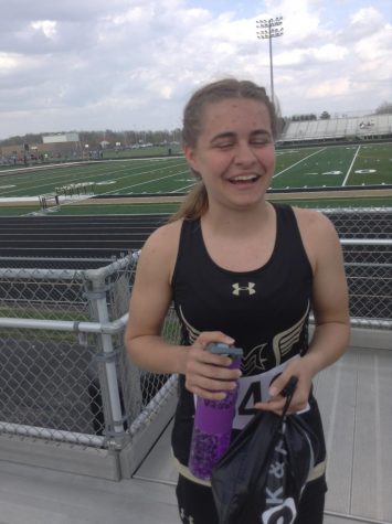 One of the track girls stands smiling after her run.