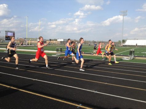 Some of the boys are on the track running for first place. 