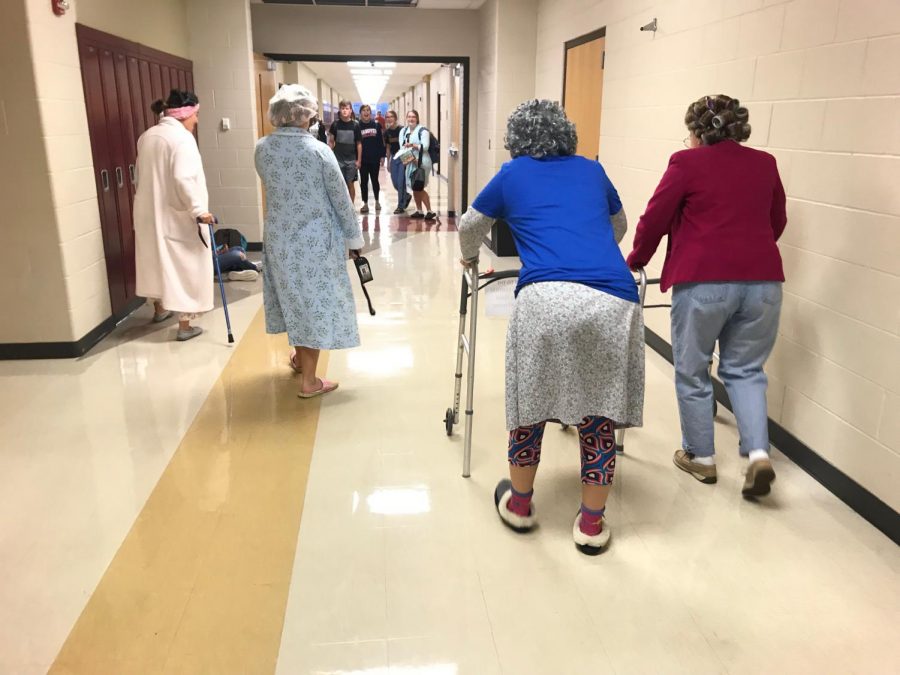 Students dressed as old people in the hallway
