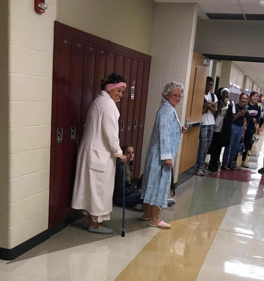 People dressed as the elderly in the hallway.