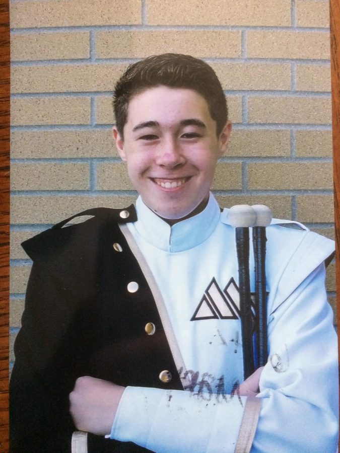 Senior Daniel Woods poses for marching band photo