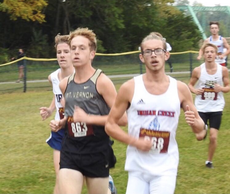 Senior Carson Collinsworth running with other cross country runners.
