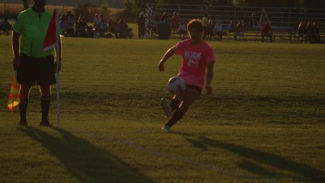 Student takes a corner kick at a boys soccer game