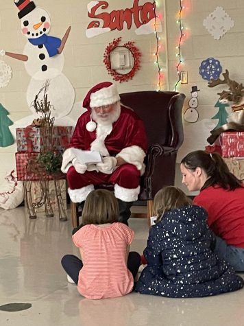 Santa reading “The Night Before Christmas” by Clement Clarke Moore.

