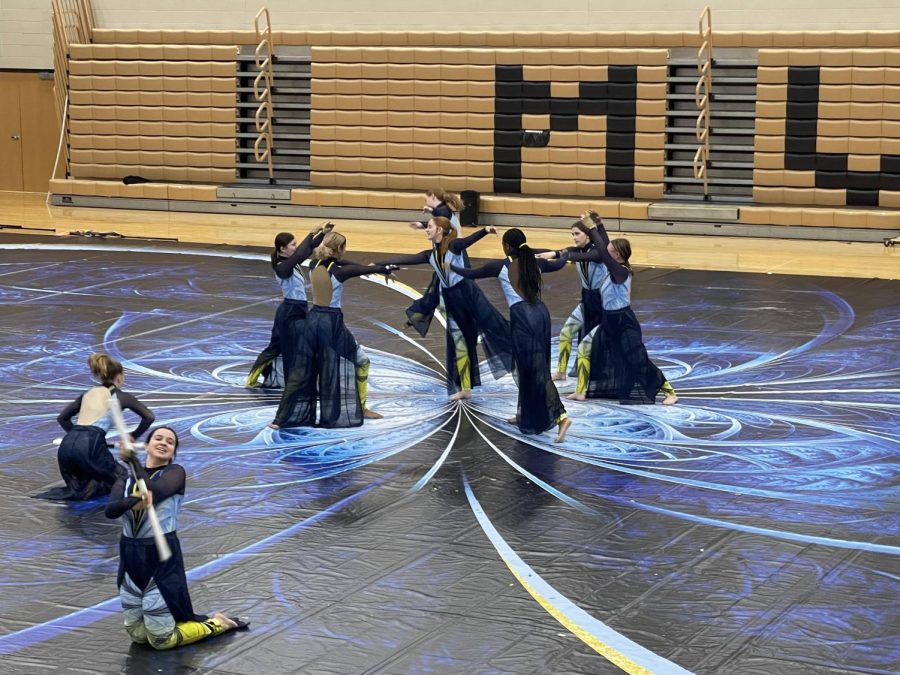 Chloe Albright of Mt. Vernon’s Color Guard team tosses a rifle as her fellow Guard mates dance.
