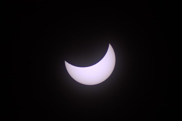 This is a partial eclipse where the moon is covering up part of the sun.  This photo was taken after the total eclipse had taken place and the moon was uncovering the sun.
