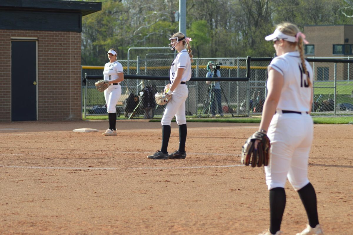 Mt. Vernon pitcher Aubrey Lowe, 10, and infielders Emma Jenkins, 10,  and Graci Hines, 11, preparing to catch. 
