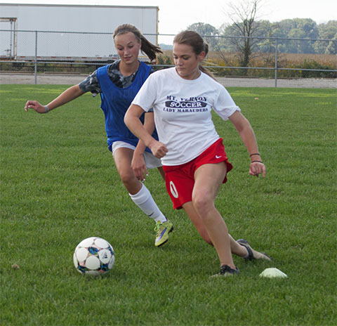 Junior Nicole Ratts and freshmen Dakota Hunziker scrimmage during a fall soccer practice. 