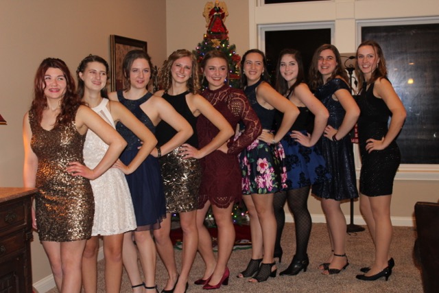 A group of seniors in their Snow Whirl dresses, standing together for a photo.