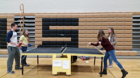 Students in the middle of a ping-pong match