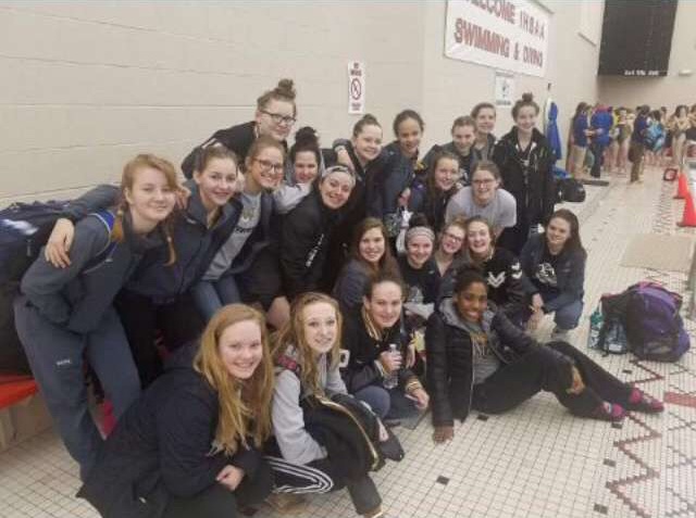 The swim girls are posing in a group picture