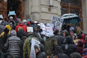 People stand in front of a building for the March for Our Lives movement.