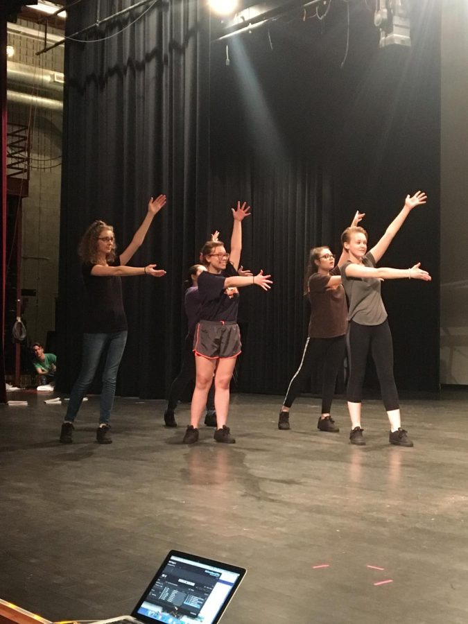 Student performers practice choreography.