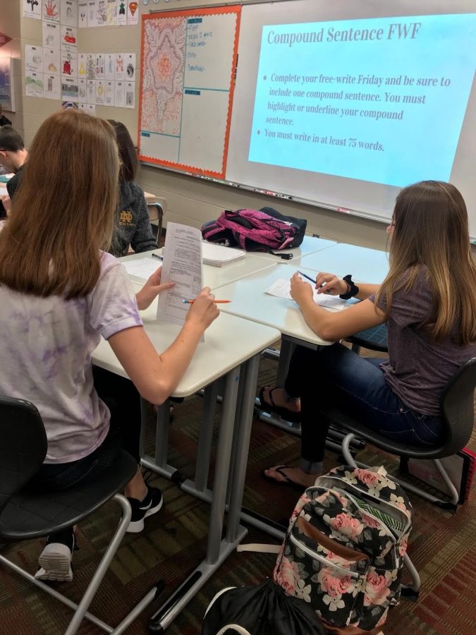 Two freshmen girls work on grammar in their English class.