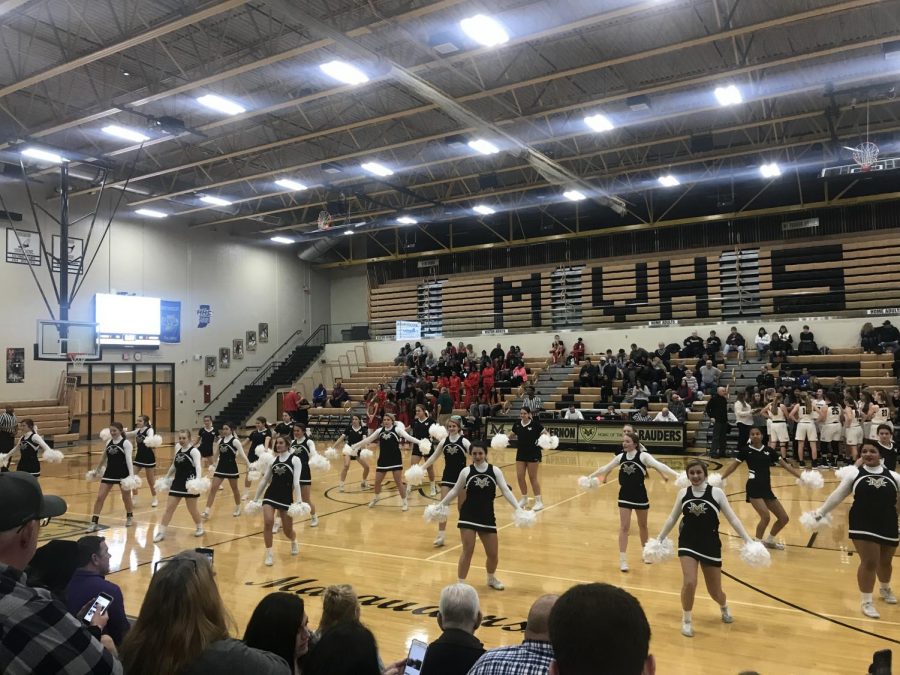 Cheerleaders dancing to the band music during 2nd quarter.