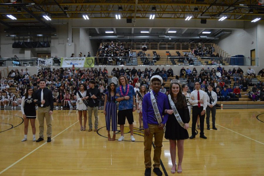 The king and the queen of homecoming are posing for pictures.