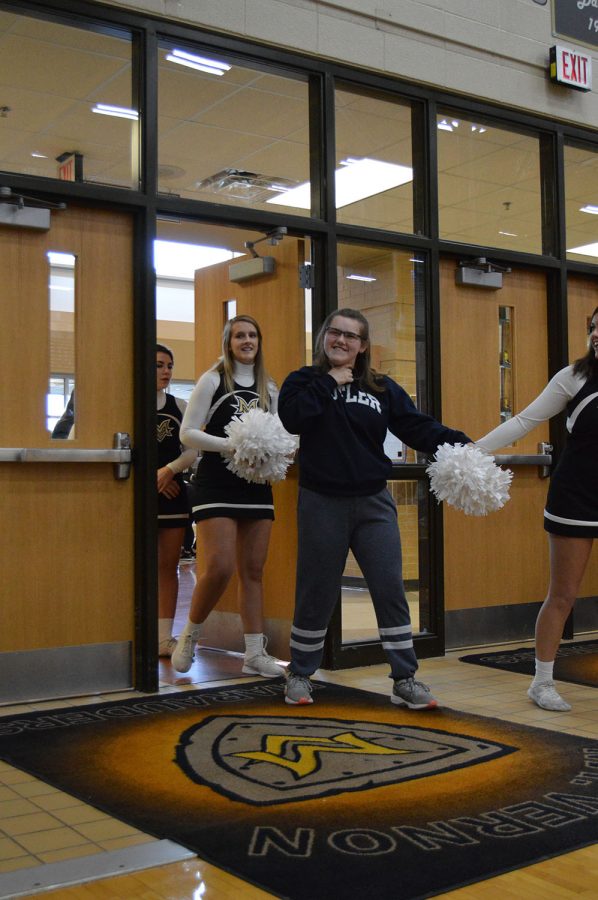 Senior cheerleaders walking in the assembly.