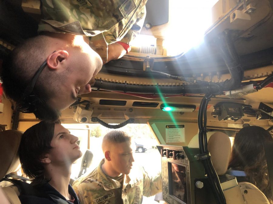 Sgt. Gabbard showing student (Elijah Burch) the trucks controls