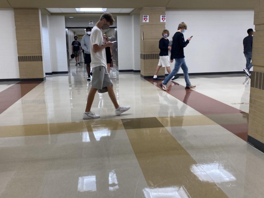 Hallways, all students have masks on and walk in one direction. 
