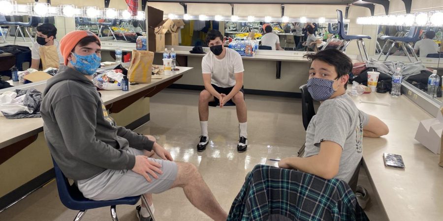 Nolan Gronowski (12), Daimon Anderson (11), and Landen Norton (12) in the guy’s dressing room apart, talking and having fun 
