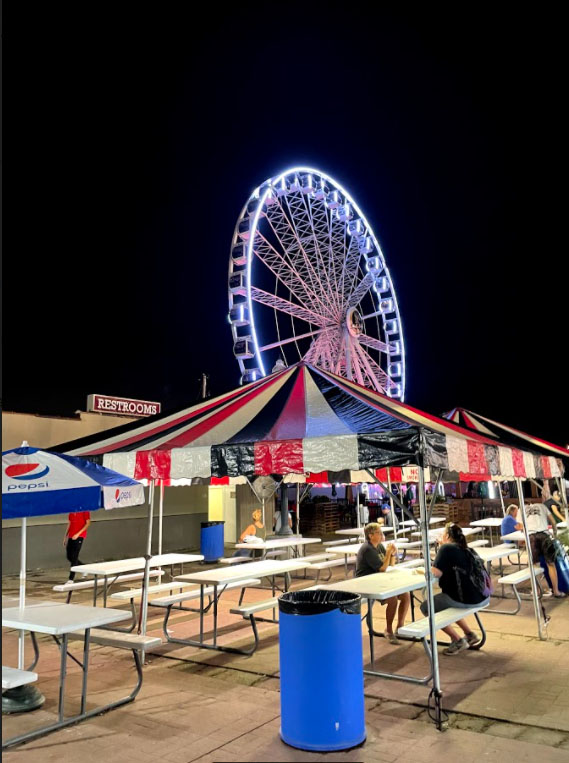 The ferris wheel lights up the night.