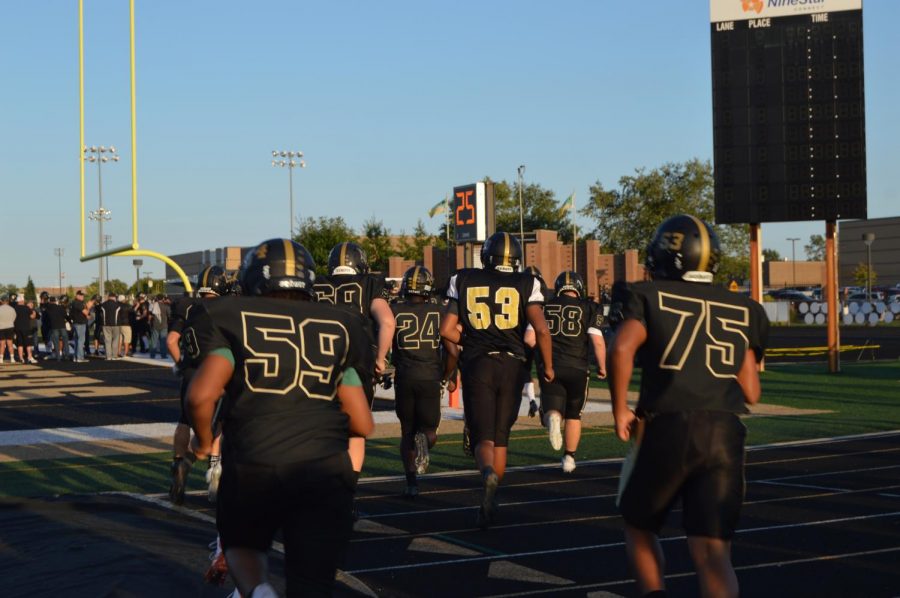 Mt. Vernon football team running out onto the field to start the game 