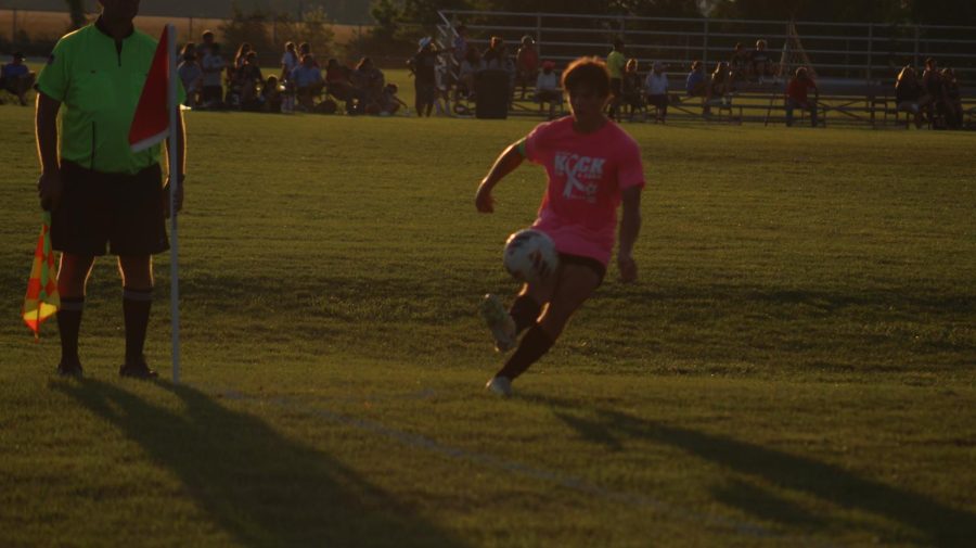 Student takes a corner kick at a boy's soccer game