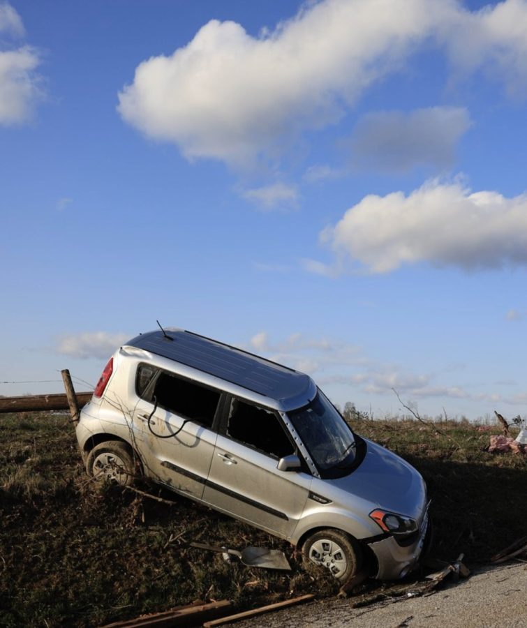 The tornado took a car and deposited it along the side of the road.
