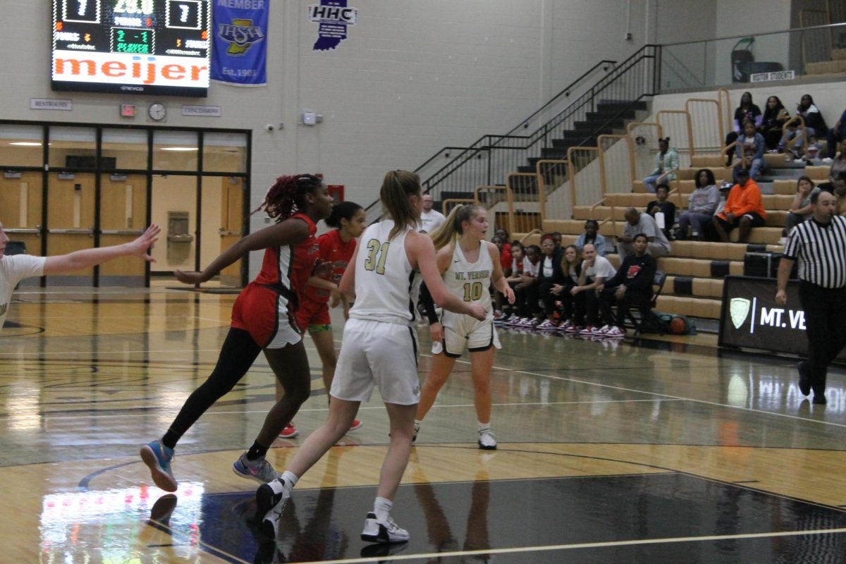  Number 31, Easton Wampler, and number 10, Reagan Britt, blocking Lawrence North.