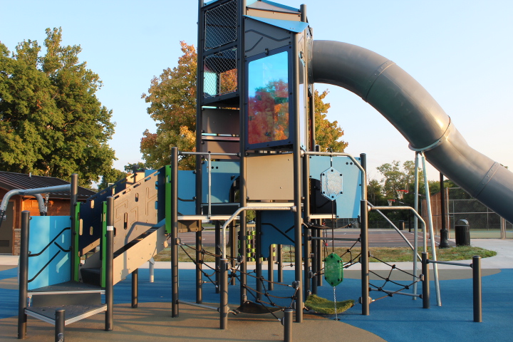 The main play place is a multi-level structure with two slides and hidden cubbies. One slide is enclosed and the other is open.
