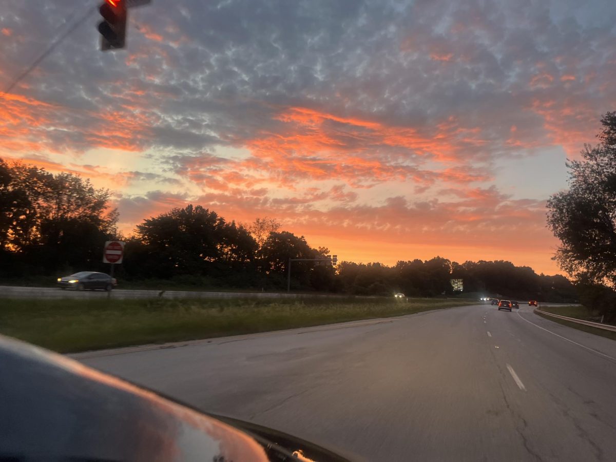 Beyond the muted colors of the road, the sky is surpassing with intense hues.